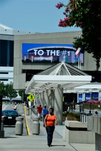 Guests enjoy a stroll along International Blvd. outside the Georgia World Congress Center on a sunny Atlanta day with a 48′x14′ billboard in the background.