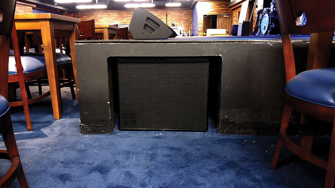 Compact self-cardioid subwoofers mounted under the stage provide smooth low-frequency coverage.