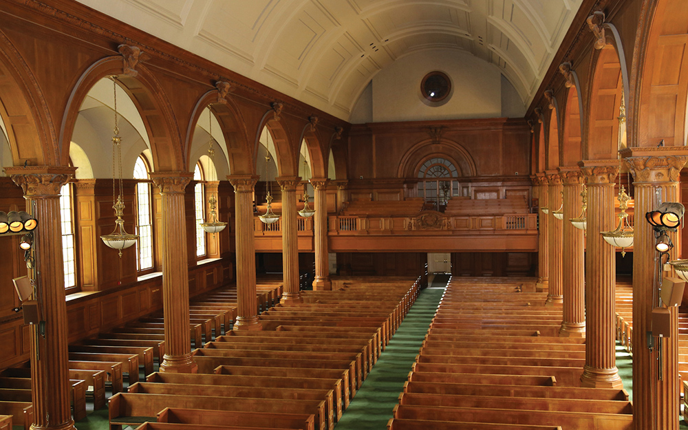 Cochran Chapel’s elegant wood paneling, as well as the 12 massive columns lining the center aisle, created many acoustic challenges for Balanced Input to overcome.