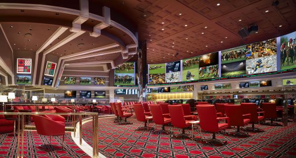 The front of the book is filled with individual carrels for horseracing fans to place their bets on 21.5 inch touchscreens; to the left of the picture, the back of the room has a stadium level view of every other sport.