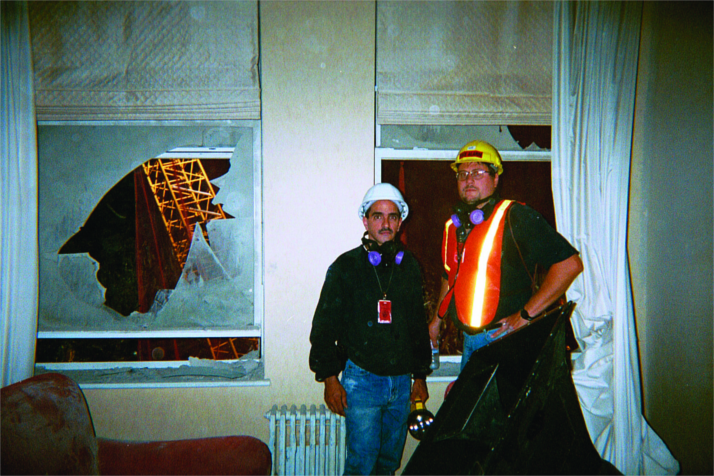 Low Voltage Systems’ Al Toledo (left) and Ed Helpeck stand with the stadium horn in a chair at location one, six stories up on Liberty Street, in someone’s apartment.
