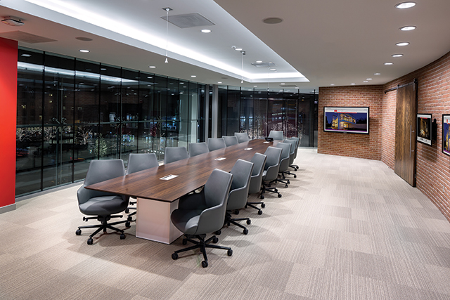 The Executive Meeting Space, located above the retail space, features a 75-inch flatscreen with touch overlay at the far end and a 46-inch on the right