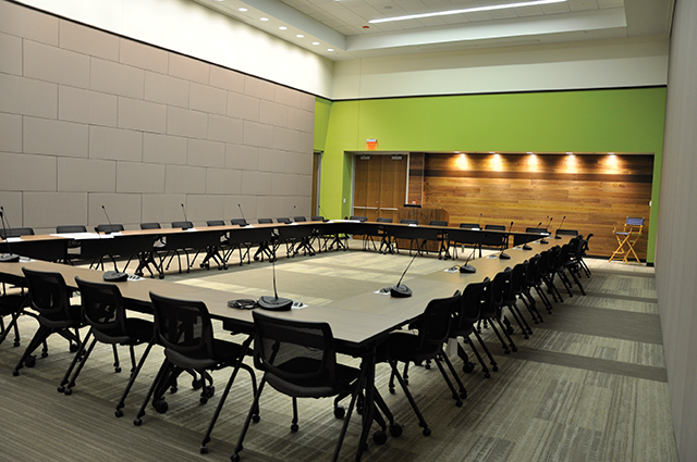 The conference microphones are set up in one of the divisible conference/training rooms.