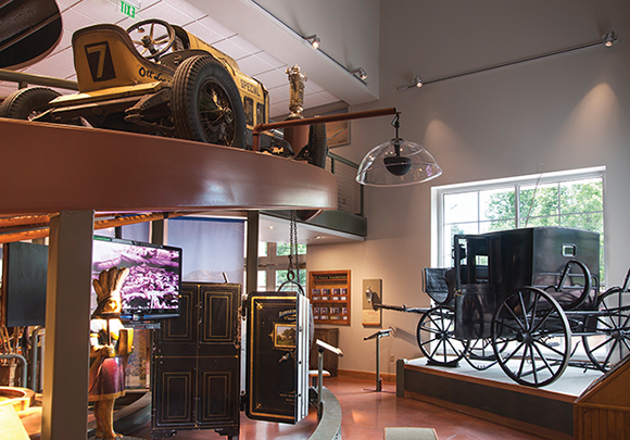 Parabolic dome loudspeakers sit above exhibits in the Carriage Museum. The two-transducer, highly focused speaker provides spoken-word information about the foundation and the area’s history, as well as the vehicle on display.