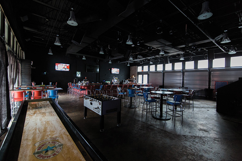 The tables and chairs are moved out of the way at night when the new Green Room DJ-dance area opens up. Three displays are located near or behind the bar, and the DJ roost’s turntable can be used to trigger video content.