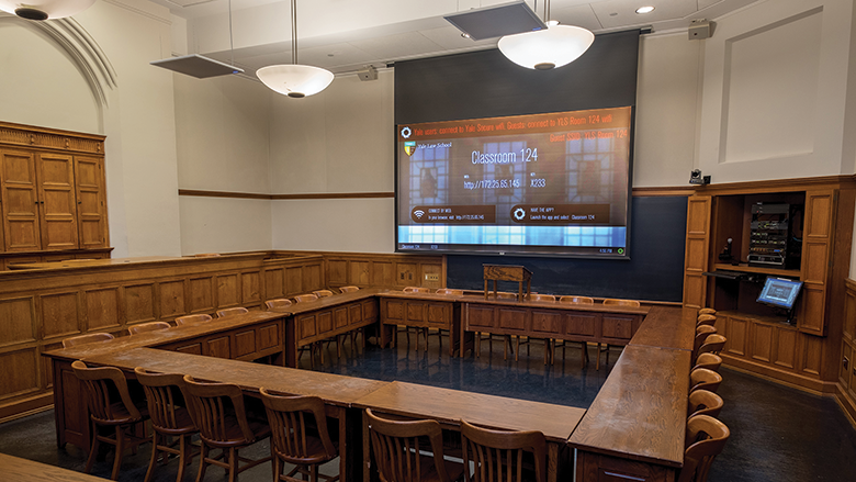 A wide view of Yale Law School classroom 124. The room’s equipped with projection, PTZ cameras, microphones and more.