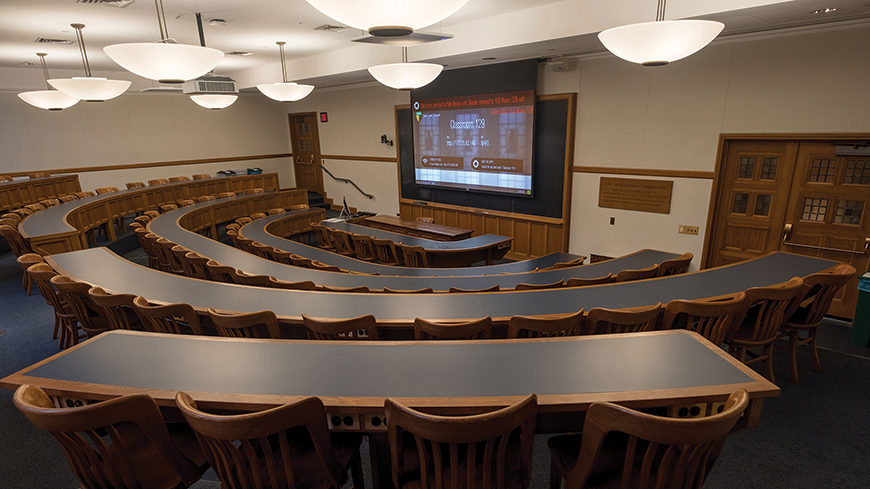 A look at Yale Law School classroom 129. There are dual microphones for lecture capture and a laser projector integrated inside.