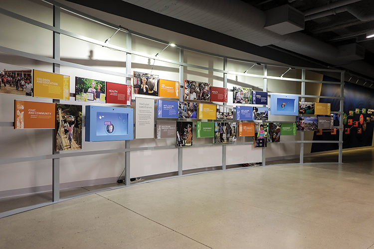 Interactive displays in the Seeds of Service gallery have integrated webcams and touchscreen displays, allowing visitors to take selfies and leave messages on the videowall.