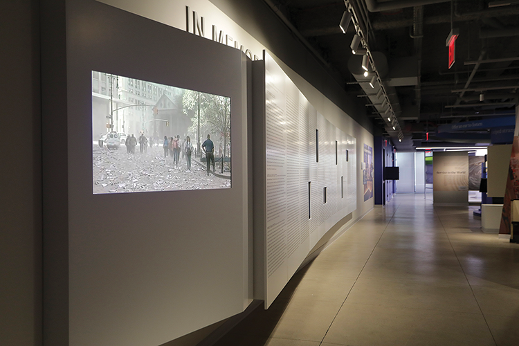 Video panels mounted into the wall of the In Memoriam gallery scroll scenes of the September 11 attacks, as well as the name of every victim.