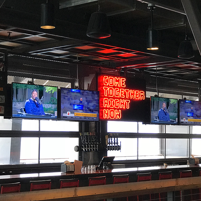 Guests in the third-floor bar can enjoy sports and other programming on 50-inch 4K displays.