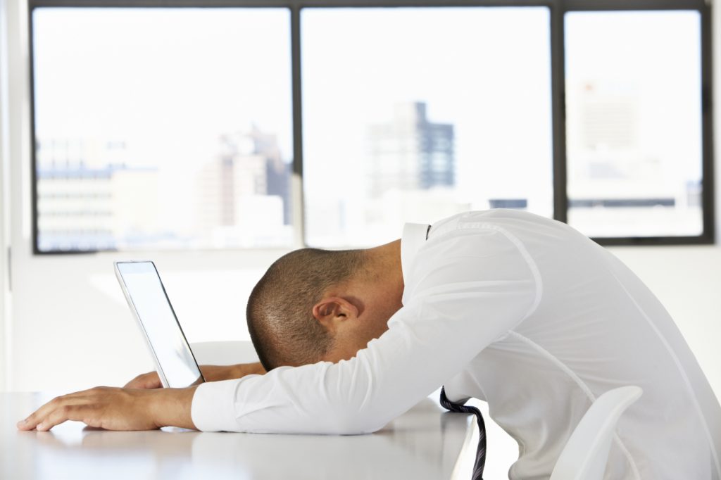 AVIXA POV, Man with head on computer