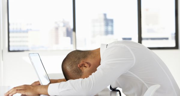 AVIXA POV, Man with head on computer