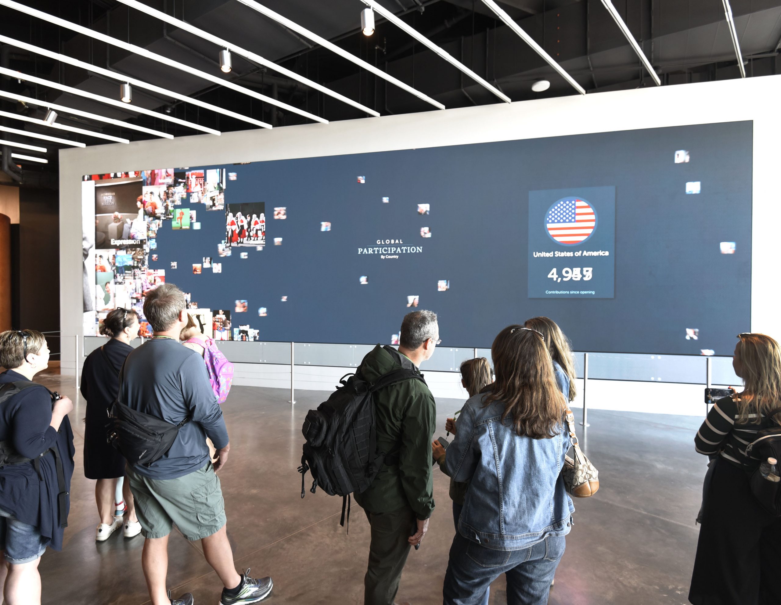 large interactive videowall being viewed by a crowd